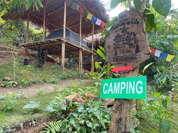 The leafy path to the camping shelters