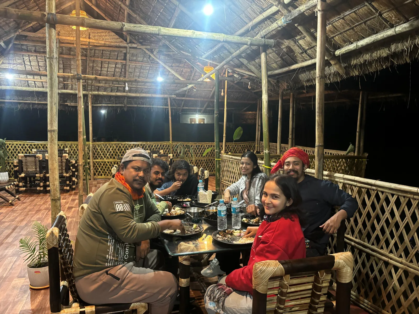 Guests sharing dinner around a table in the bamboo restaurant