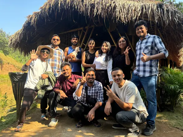 Friends gathered outside the bamboo shelter